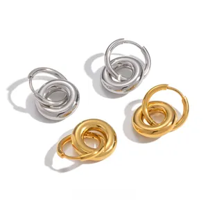 Detailed view of interlocking circle earrings in gold and silver stainless steel finish