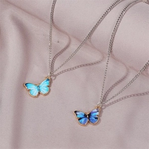 Close-up of adjustable butterfly bracelets featuring gradient blue enamel and sparkling zircons