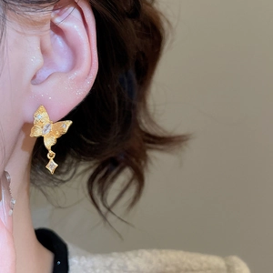 Detailed macro view of 24K gold plated butterfly earring with sparkling zircon stones