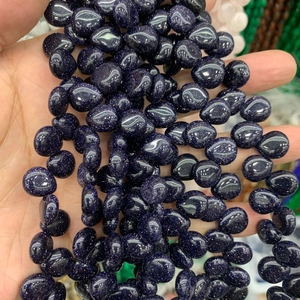 Close-up of sparkling dark blue teardrop crystal beads for DIY jewelry making