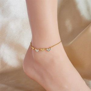 Elegant gold titanium anklet featuring heart charms and blue mother of pearl on satin