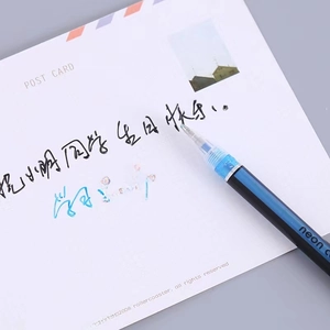 Neon glitter gel pen with light blue ink writing on a card, dark blue body style