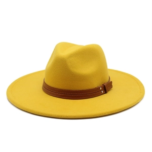 Detail of bright yellow wool fedora hat with a brown leather band and metal rivets