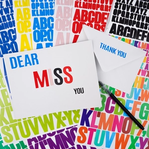Close-up of colorful alphabet stickers applied to a greeting card for DIY scrapbooking