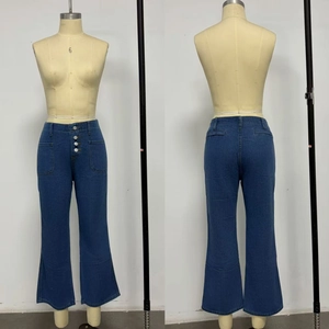 Detail view showing high waist button fly design on dark blue wide leg denim jeans