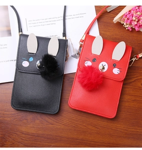 Detail of cute rabbit-shaped mini crossbody bags with decorative ears and plush ball