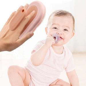 Pink silicone baby bath brush with soft bristles and ergonomic hand grip handle