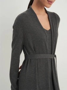 Detail of soft charcoal grey knitted cardigan texture with adjustable waist tie