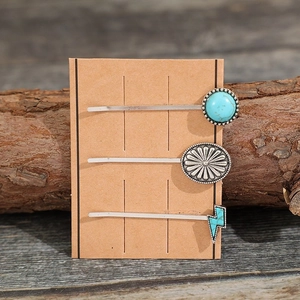 Set of 3 vintage bohemian turquoise and floral metal hair pins on a rustic wood background