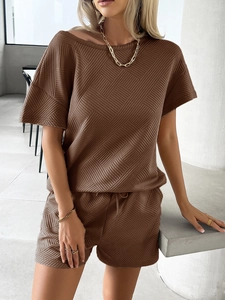 Detail of brown knit two-piece set showing geometric texture and drawstring elastic waist