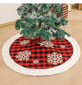 Detailed view of red and black plaid Christmas tree skirt with plush white faux fur trim