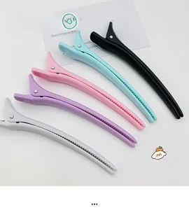 Macro detail of long matte alligator hair clips in five pastel macaron colors