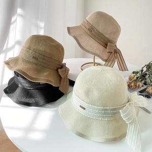 Breathable woven bucket hats in beige, khaki, and black with elegant side ribbon bows