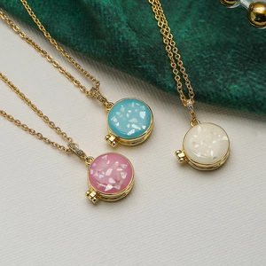 Gold-plated locket necklaces with blue, pink and white opal-style circular pendants