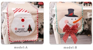 Detail of burlap Christmas table runners featuring Santa Claus and Snowman embroidery