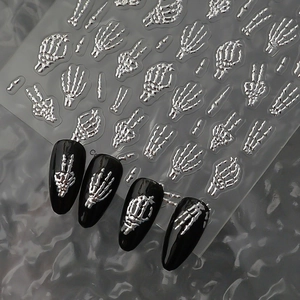 Detailed 3D silver skeleton hand nail stickers with metallic relief on black nails