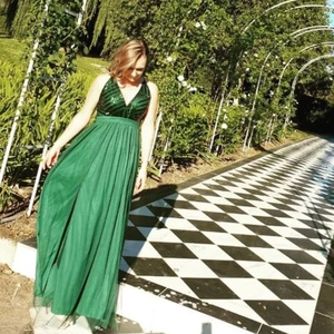 Detail of sequin embroidery on V-neck bodice and layered green tulle evening gown
