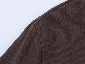 Close-up of high-quality stitching and dark brown knit texture on women's linen set