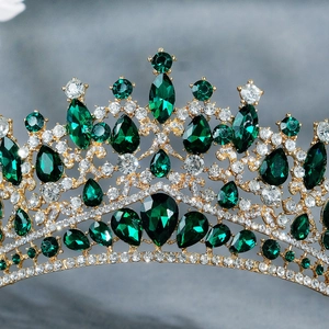 Luxury gold crown with emerald green teardrop gemstones and sparkling white diamonds