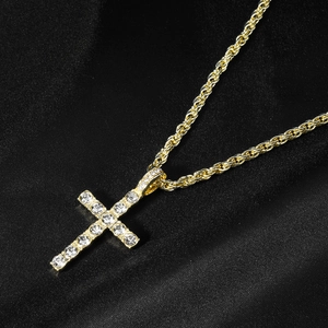 Close-up of hip hop gold cross pendant with white rhinestones on black silk