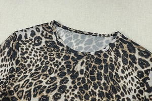Detailed view of leopard print sheer mesh fabric with classic crew neck design