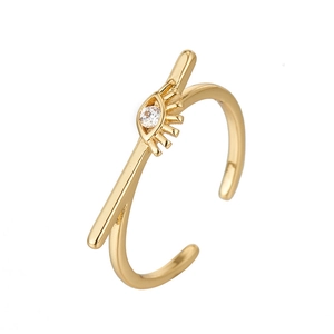 Detail of gold adjustable ring with eye motif, arrow element and sparkling zircon stone