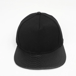 Detail of black snapback hat featuring a flat brim with faux snakeskin leather texture