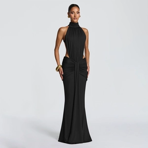Detail of elegant backless black evening gown featuring waist cut-outs and fishtail hemline