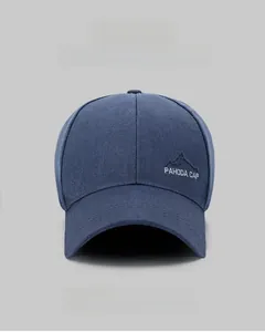 Detail view of the mountain peak embroidery and cotton fabric on a navy baseball cap