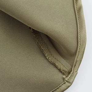 Detail of olive green twill fabric showing exquisite stitching and lockstitch seams