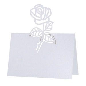 Close-up of laser-cut rose hollow place card in white pearlescent paper for weddings