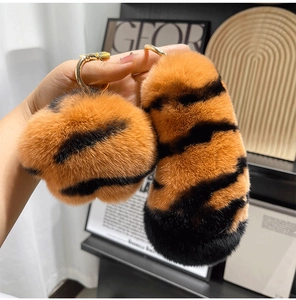 Detail of tiger pattern plush keychain with soft faux rabbit fur and gold metal ring