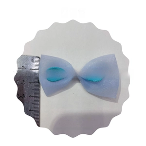 Detail of a 5cm light blue mesh bowknot accessory with string detail for DIY hair clips