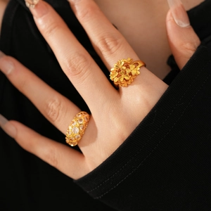 Macro detail of 24k gold plated flower cluster and grid zircon ring set on finger