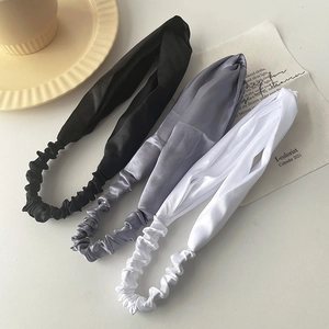 Three-color set of elegant satin twist headbands for women in black, grey, and white
