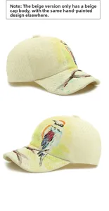 Detail of beige straw baseball caps featuring artistic hand-painted colorful bird patterns