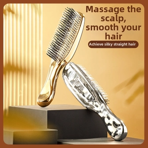 Modern gold and silver ergonomic massage hairbrushes with smooth metallic mirror finish