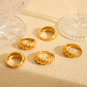 Five-piece 18K gold plated croissant dome rings set displayed on a beige linen fabric