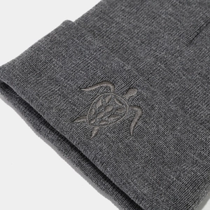 Dark grey knitted beanie featuring a turtle embroidery and ribbed cuff design