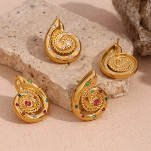 Detail of 18K gold plated spiral shell earrings with multicolored and white rhinestones