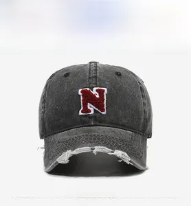 Detail of vintage washed black cotton baseball cap with red towel embroidered N letter