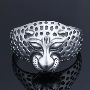Macro shot of silver stainless steel leopard head ring with detailed spotted texture