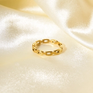 Macro shot of 18K gold plated stainless steel anchor link ring on a satin background