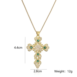 Detail of gold-plated cross pendant with green heart zircon stones and 4.4cm height
