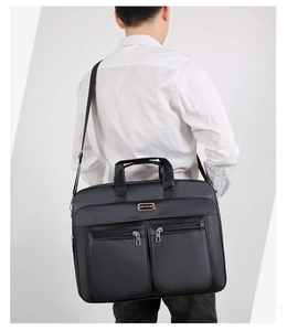 Male model wearing black 20-inch waterproof oxford shoulder bag for business commute