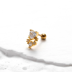Macro shot of gold stainless steel screw-back earring with heart-shaped zircon stone