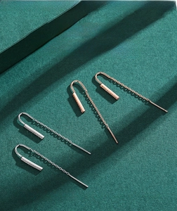 Detail view of long S925 sterling silver chain earrings with sleek bar pendants and crystals