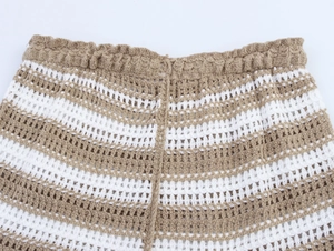 Detailed close-up of khaki and white striped crochet knit shorts with elastic waistband