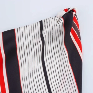 Macro shot of striped fabric texture in red black and white with detailed woven finish