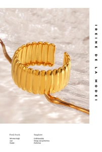 Macro view of 18K gold plated wide ribbed ring showing vertical textured metal details
